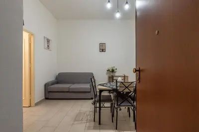 a room with a table and chairs and a couch at I Mori-holiday apartment in Palermo