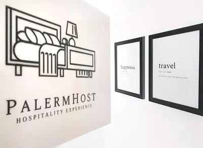 three framed illustrations of a bed on a wall at PalermHost in Palermo