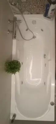 a white bath tub with a green plant in it at PalermHost in Palermo