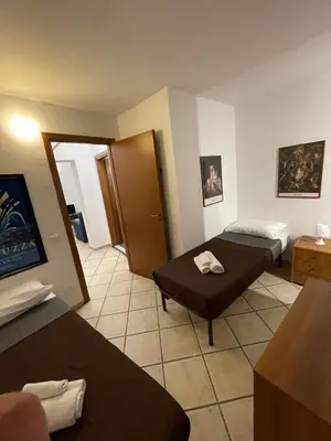 a hotel room with two beds and a table at Sicooli apartments via Materassai 46 in Palermo