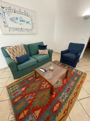 a living room with a green couch and a coffee table at Sicooli apartments via Materassai 46 in Palermo