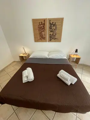 a bedroom with a bed with two towels on it at Sicooli apartments via Materassai 46 in Palermo