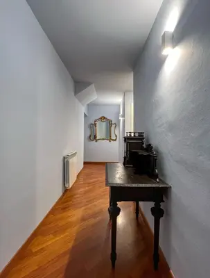 a room with a table and a mirror on a wall at Le Radici casa vacanze in Palermo