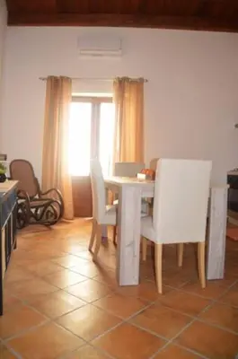 a dining room with a white table and chairs at Vecchio Cortile Home Holidays in Palermo