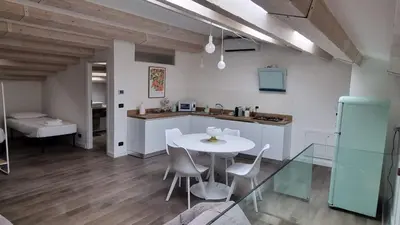 a kitchen and dining room with a white table and chairs at 2 Sicilie Rooms and Suite in Centro in Palermo