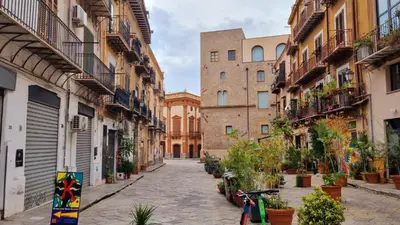 an alley in an old city with a bike parked on the street at 2 Sicilie Rooms and Suite in Centro in Palermo