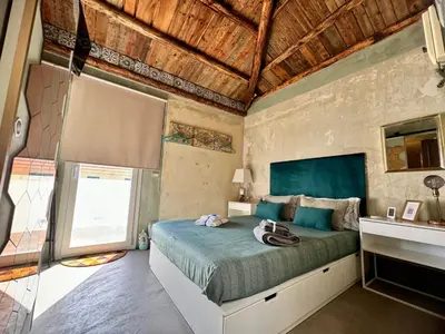a bedroom with a bed and a large window at A Nicuzza in Palermo