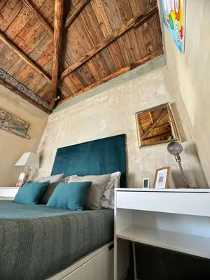 a bedroom with a bed with a wooden ceiling at A Nicuzza in Palermo