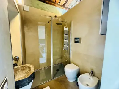 a bathroom with a shower and a toilet and a sink at A Nicuzza in Palermo