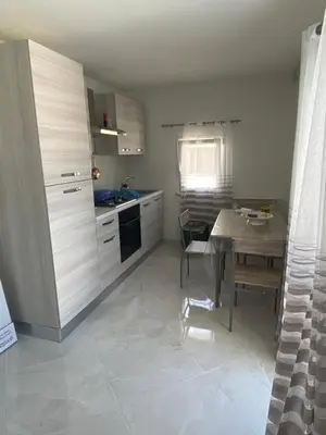 a kitchen with a table and a dining room at Casa vacanza solemare in Balestrate