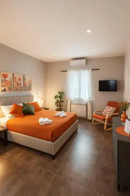a bedroom with a large bed and a living room at Marine Case Vacanze in Palermo