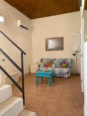 a living room with a couch and a table at Casa Vacanza Sicilia Dolce Mare in Balestrate