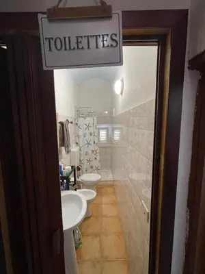 a bathroom with three sinks and a sign that reads toilets at Casa Vacanza Sicilia Dolce Mare in Balestrate