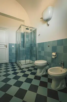 a bathroom with two toilets and a glass shower at Villa Bona in Termini Imerese