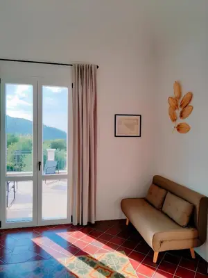 a living room with a couch and a sliding glass door at Villa Bona in Termini Imerese