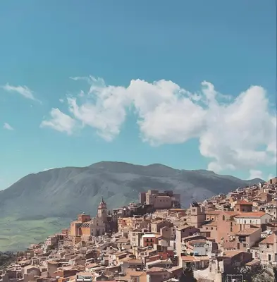a town on a hill with mountains in the background at Villa Bona in Termini Imerese