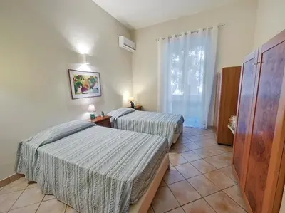 a bedroom with two beds and a window at Annacati House Centro Storico in Palermo