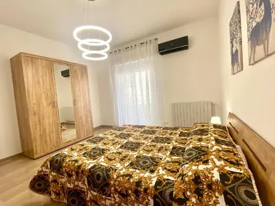 a bedroom with a bed and a large mirror at Alka Home, 7 km dal mare in Alcamo