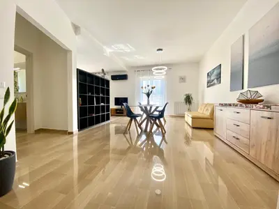 a kitchen and living room with a table and chairs at Alka Home, 7 km dal mare in Alcamo