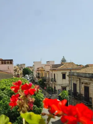 a view of a city with red flowers and buildings at Àrima Mondello Apartment in Mondello