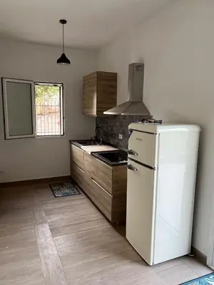 a kitchen with a white refrigerator and wooden cabinets at Villa Simo in Altavilla Milicia
