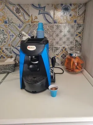 a blue and black coffee maker on a counter at Magnolia in Campofelice di Roccella