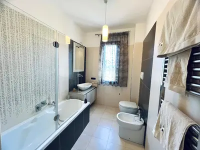 a bathroom with a tub and a toilet and a sink at Rosa di Mare in Capaci