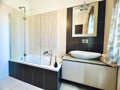 a bathroom with a tub and a sink and a mirror at Rosa di Mare in Capaci