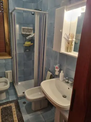 a bathroom with a sink and a toilet and a shower at Blu horizon in Campofelice di Roccella