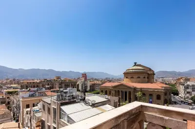a view of a city from the roof of a building at Le Gemme di Cavour Luxury Rooms in Palermo