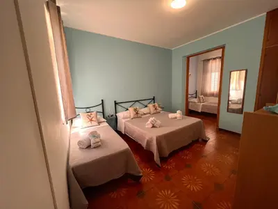 a room with two beds and a mirror at Celeste Rooms in San Vito lo Capo