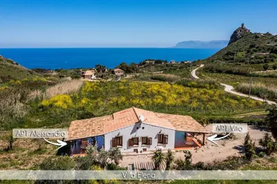 a house on a hill next to the ocean at Villa Elena 2 Km from the Natural Reserve of Zingaro in Scopello