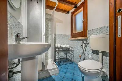 a bathroom with a sink and a toilet at Villa Elena 2 Km from the Natural Reserve of Zingaro in Scopello