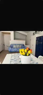 a vase of flowers on a table in a kitchen at Casa Vacanze Villa Ale in Altavilla Milicia