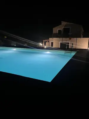 a swimming pool at night with blue illumination at Casa Vacanze Villa Ale in Altavilla Milicia