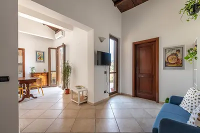a living room with a blue couch and a table at The Terrace Behind the Cathedral by Wonderful Italy in Palermo