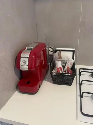 a red toaster sitting on a counter next to a basket at Casa Marele in Palermo
