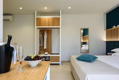a bedroom with a bed and a bowl of fruit on a table at IL MARE DENTRO SUITES in San Vito lo Capo
