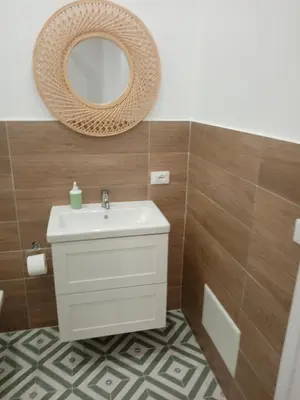 a bathroom with a sink and a mirror at Egea Casa Vacanza in Capaci