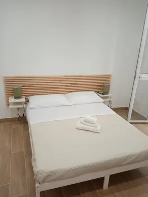 a bedroom with a bed with two towels on it at Egea Casa Vacanza in Capaci