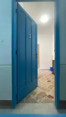 an open blue door in a room with a tile floor at APPARTAMENTO MAESTRALE in Balestrate