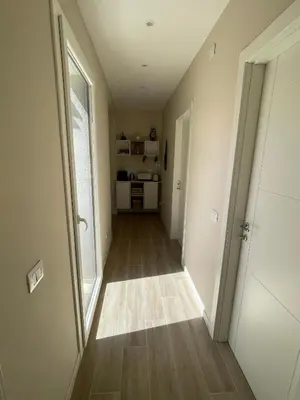 an empty hallway with a door to a kitchen at Martanna Rooms in Carini