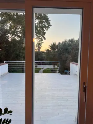 a sliding glass door looking out onto a patio at La Casa di Dada in Terrasini