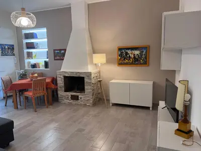 a living room with a table and a fireplace at La Casa di Dada in Terrasini