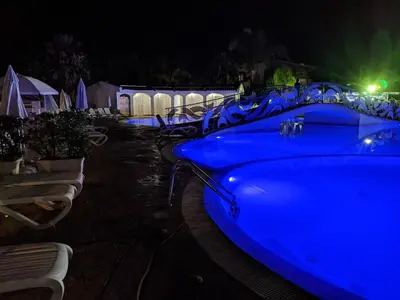 a row of blue tables and chairs at night at Casa Vacanze Villa Pomelia in Campofelice di Roccella