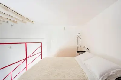 a white bedroom with a bed in a room at A casa di Simona in Palermo