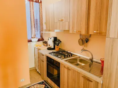 a kitchen with a sink and a stove top oven at Casa Vacanza Stella Maris in Isola delle Femmine