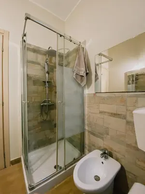 a bathroom with a shower and a toilet and a sink at Casa Vacanza Stella Maris in Isola delle Femmine