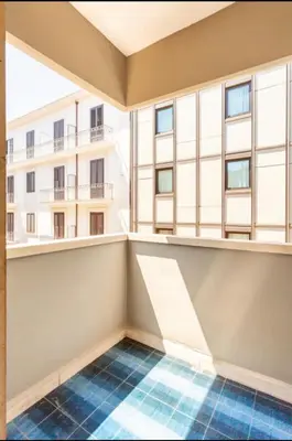 a white bedroom with a bed and a table and chairs at La Dimora dei Teatri, Luxury rooms in Palermo