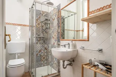 a bathroom with a toilet and a sink and a shower at [La Maiolica] - Centro storico in Palermo